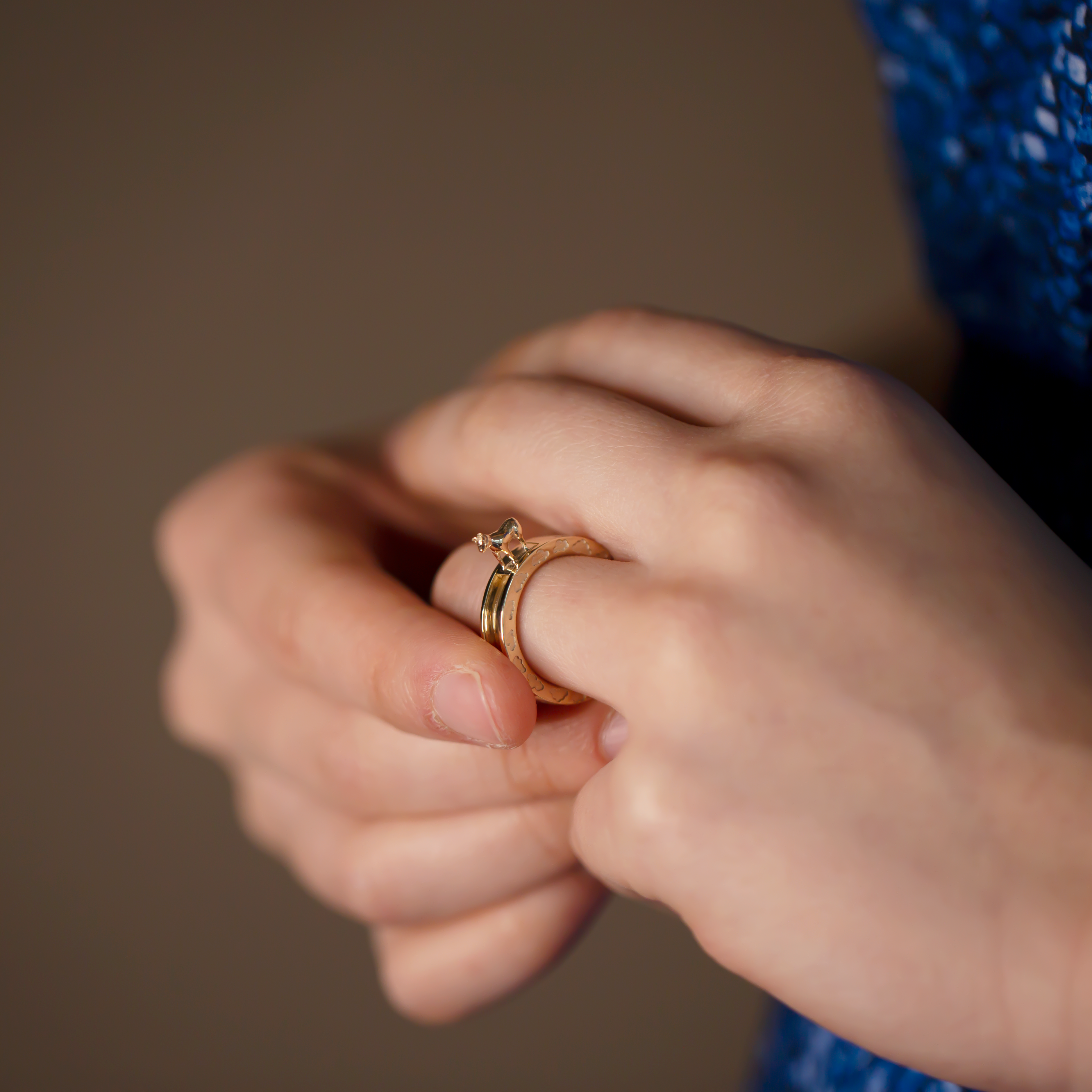 14K yellow gold Year of the Ox zodiac ring cloud pattern kinetic ring designer fine jewelry on model