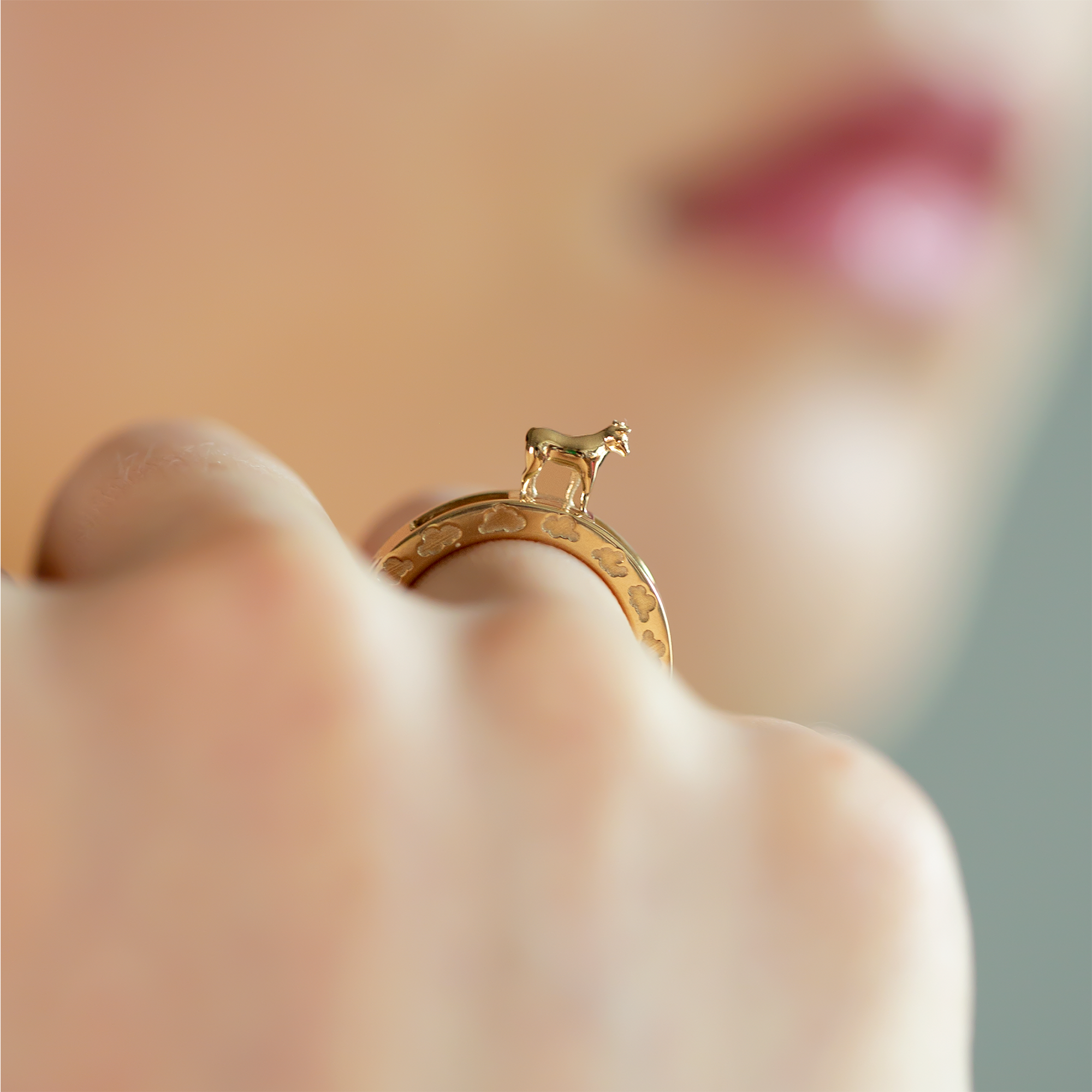 14K yellow gold Year of the Ox zodiac ring cloud pattern kinetic ring designer fine jewelry on model